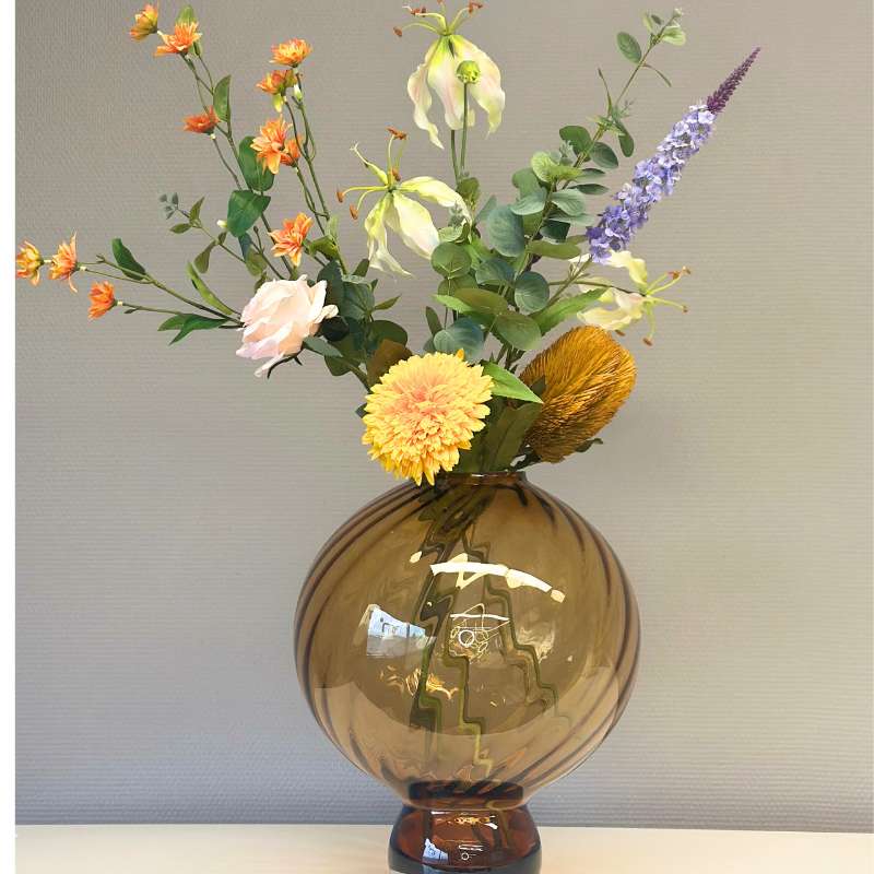 Mondgeblazen glazen Fridio vaas met een kunstbloemen boeket van BloomFever met voornamelijk oranje tinten